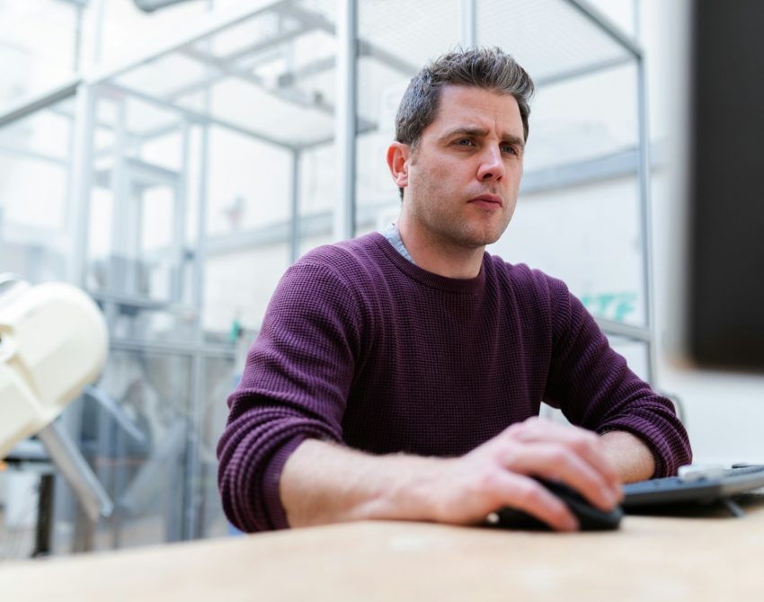 Man on computer at desk, Integrated solutions and ancillaries | High Dream